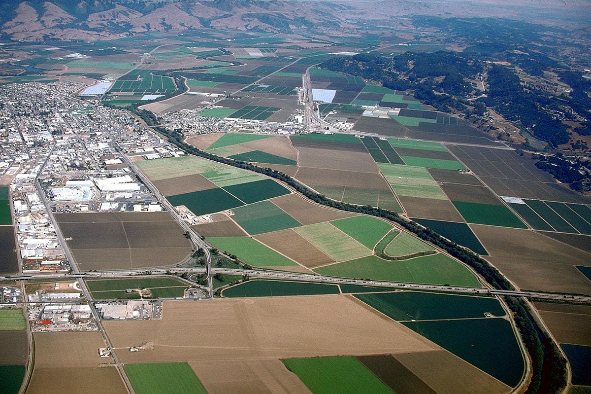 Aerial image of flooding caused by a breach in the Pajaro River levee during a 1995 storm. Inundation in the City of Watsonville and the town of Pajaro in the background.