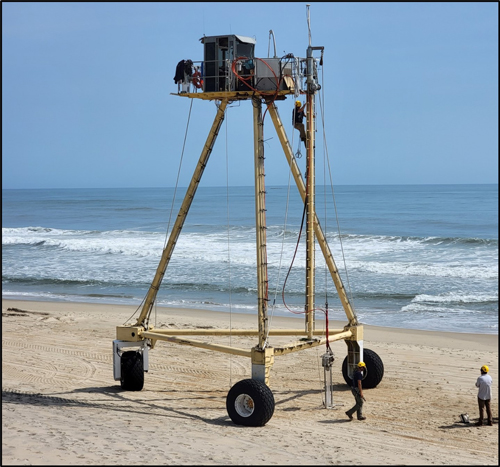 Project team testing the deployment of a vibracore off the CRAB on the beach in front of the ERDC CHL Field Research Facility (FRF) at Duck, NC.  (Photo credit: Sean McGill)